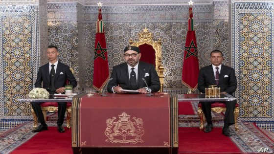 In this photo provided by the Moroccan News Agency (MAP), Morocco's King Mohammed VI, center, accompanied by his son Crown Prince Moulay Hassan, left, and brother Prince Moulay Rashid addresses the Nation in a speech aired on TV, at the Royal Palace in Tetouan, Morocco, on Monday July 29, 2019. Morocco’s king is calling for a government reshuffle, seeking “new blood” and saying the country’s current development policy isn’t doing enough to meet Moroccans’ needs. In a speech Monday night marking his 20 years on the throne, King Mohammed VI reproached the Islamist-led government and tasked Prime Minister Saad-Eddine El Othmani with proposing new government candidates in the fall. (Moroccan Royal Palace via AP)