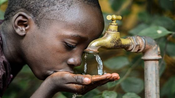 Symbol for Hope and Malnutrition in Africa. Little African boy happy finally getting water.